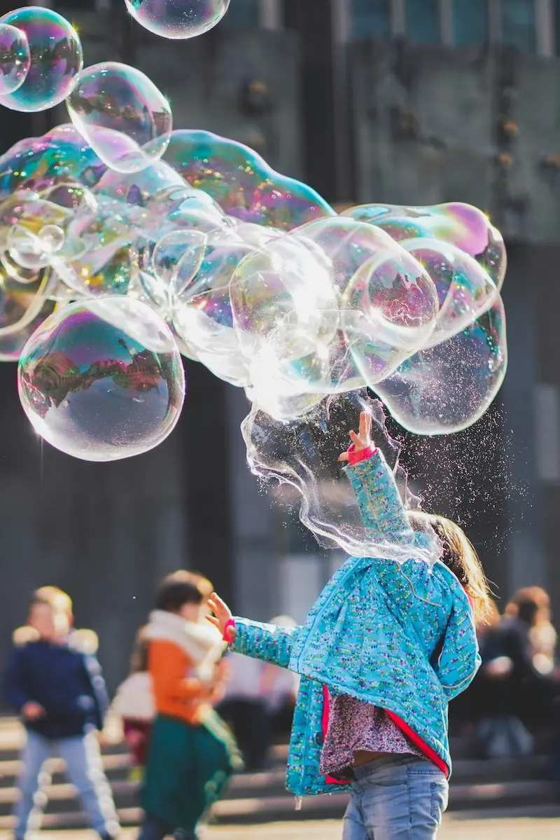 Girl making giant bubbles